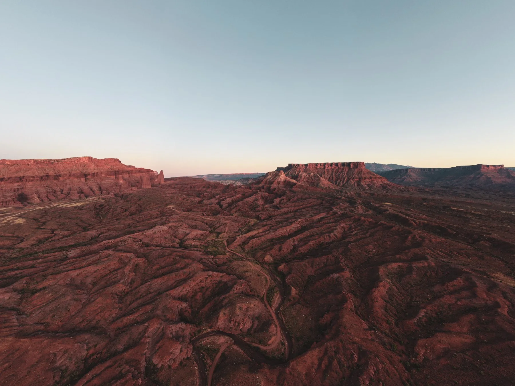 An aerial view of the red-rock landscape near Moab at sunset