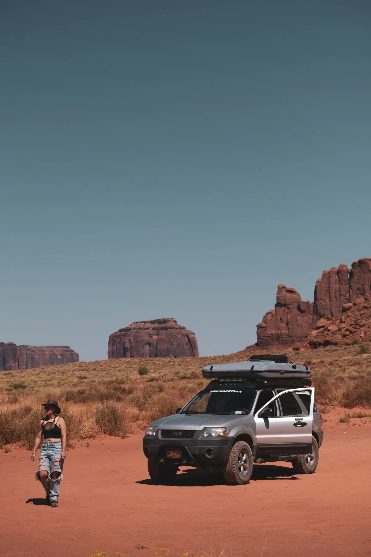 Sofia beside the Ford Escape in Monument Valley