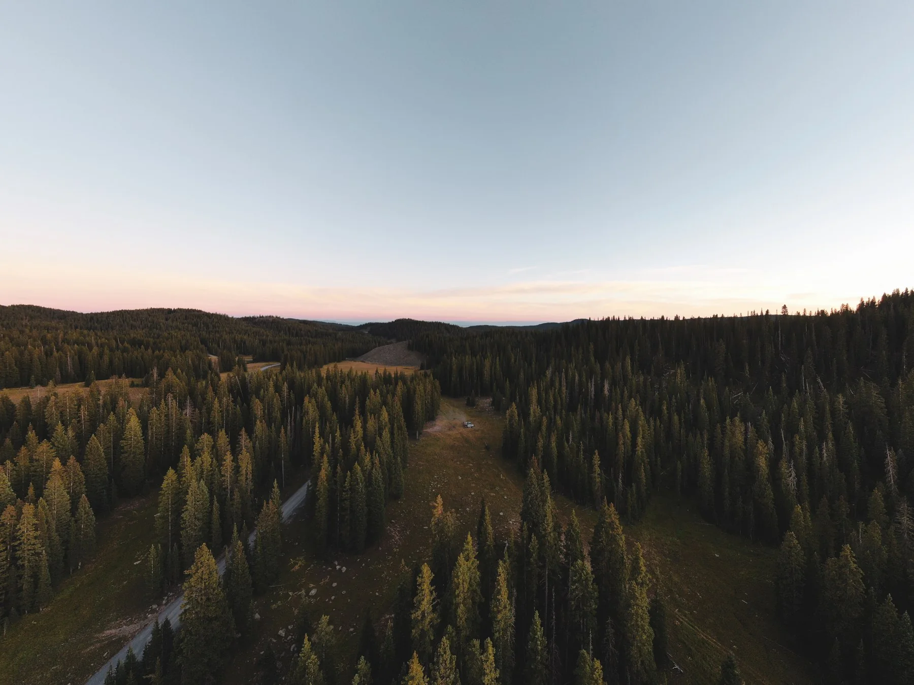 An aerial view of a forest clearing near Twin Lakes in evening light